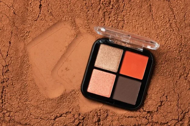 Palette de maquillage avec fards aux teintes cuivre, bronze, or, prune et nude sur une table élégante